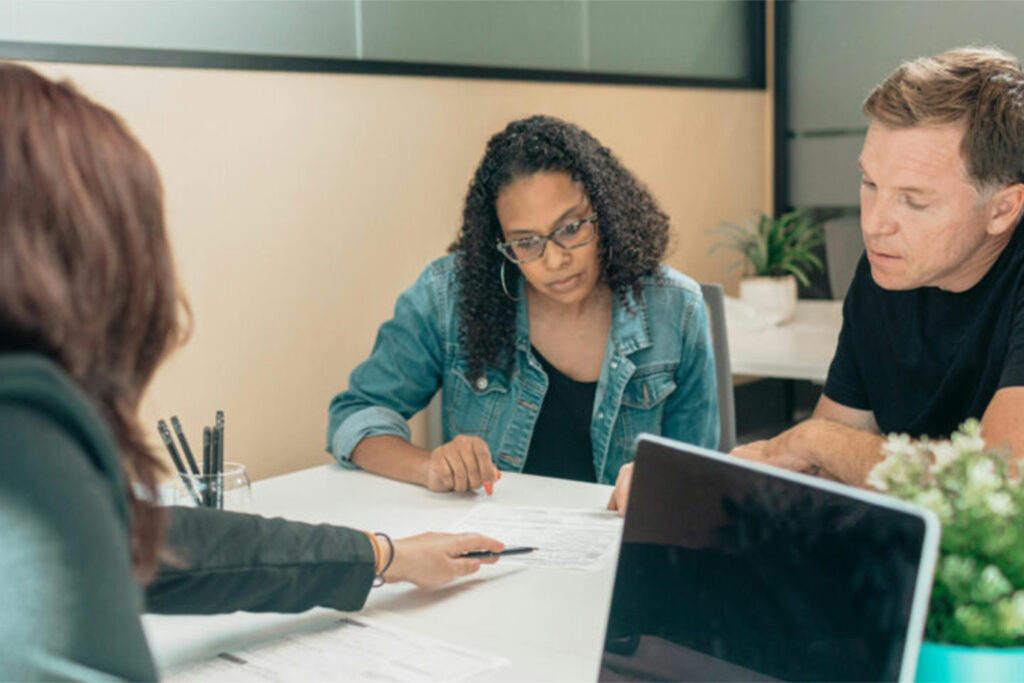 A Realtor helping a couple through the process of renting a property.