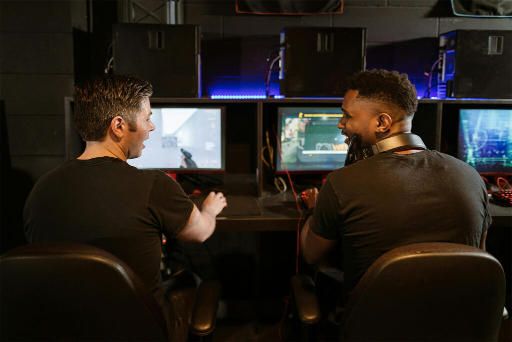 Two people playing and developing video games