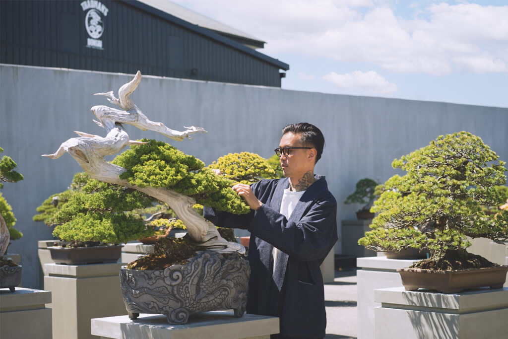 An image of Teppei Kojim tending to his bonsai when interviewed by LUXE Magazine