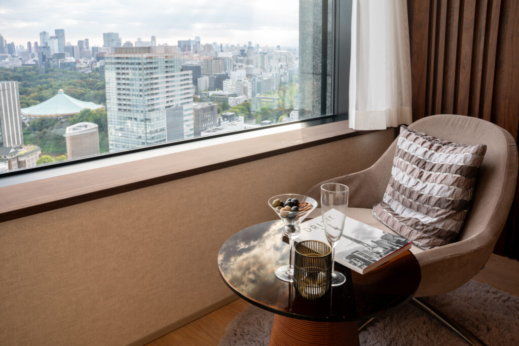 An image of the interior of The La Tour Chiyoda, showing a chair in the bedroom with great park views . Apartment for sale in Shibuya, Tokyo, Units for sale with Housing Japan