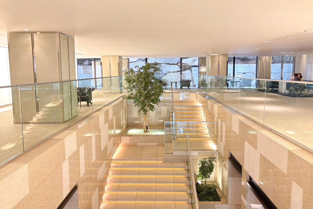 An image of the interior of Park Court Toranomon Atago Tower, showing an entrance area with marble and glass. Apartment for sale in Minato, Tokyo, Units for sale with Housing Japan