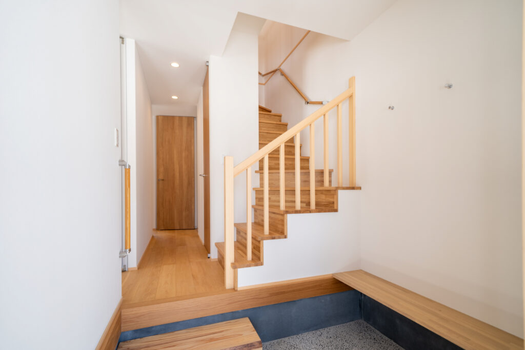 An image of the newly developed Iwatake Terrace Rental showing the entrance way and staircase with wooden finishes.