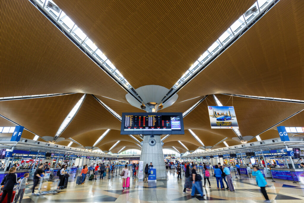 An Image of the Interior of the Kuala Lumpur International Airport in Malaysia showing dramatic roof structure providing shelter while allowing natural ventilation