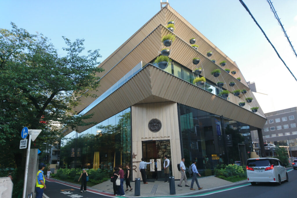 Starbucks Reserve Roastery Tokyo exterior designed by Kengo Kuma featuring wooden eaves and hanging planters in Nakameguro