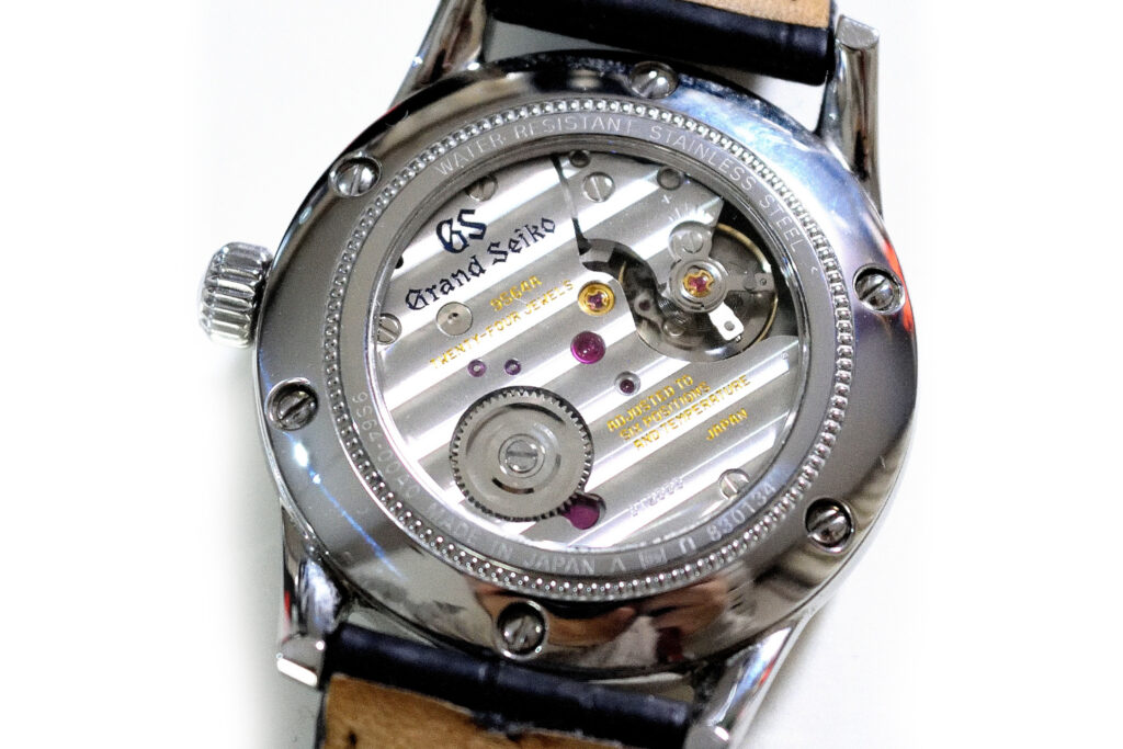 A close-up image of the Grand Seiko 9S64 Hand Wound Movement from the back of a watch.