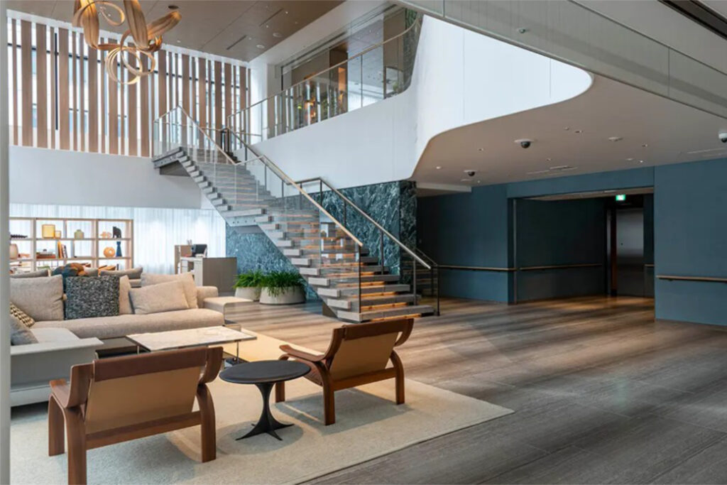 Lounge at World Tower Residence with an open staircase, marble wall panel and low seating