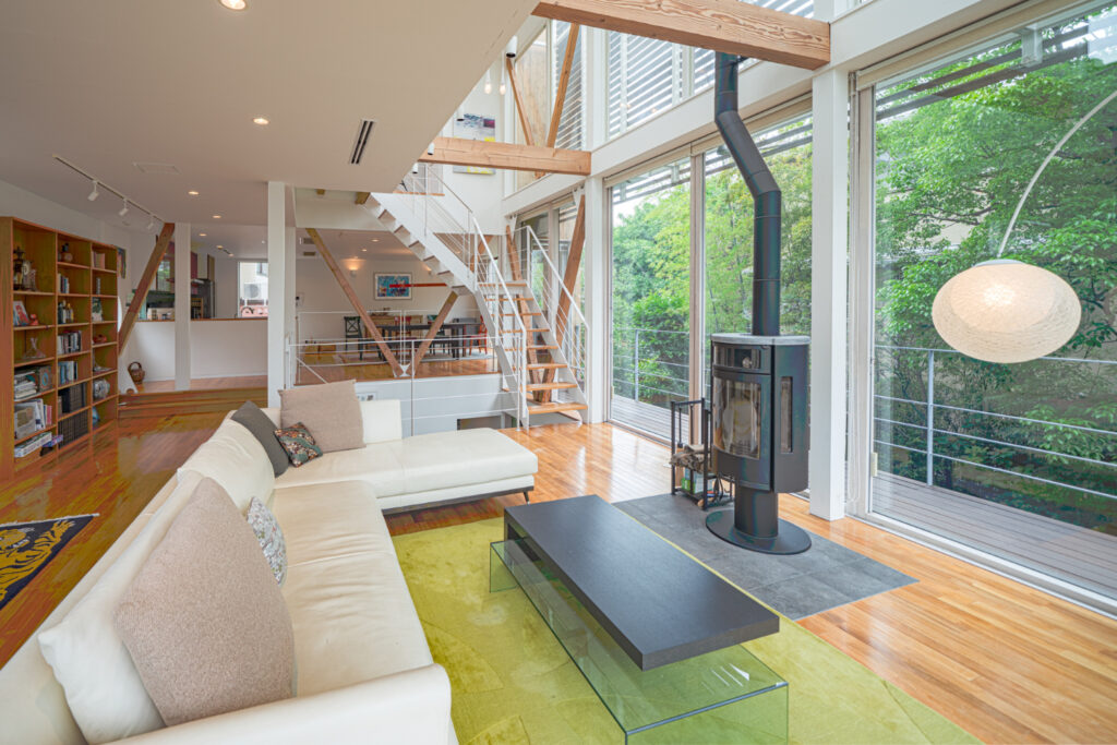 Kamakura Hase House, Luxurious living area with large windows and wood burning fireplace.