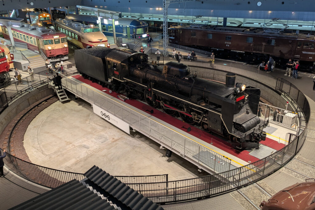 The Railway Museum, Omiya showing multiple trains and a steam train on a turn table.